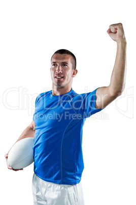 Confident rugby player flexing muscles