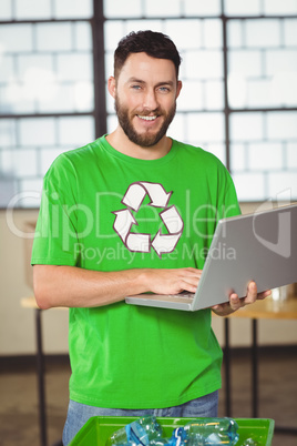 Portrait of happy man using laptop