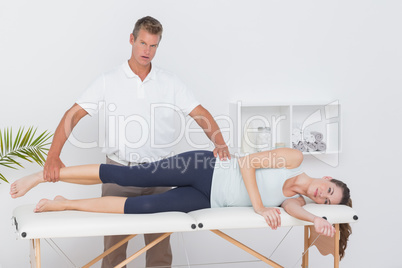 Doctor examining his patient leg