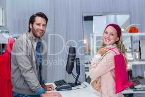 Smiling cashier and his customer