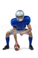 American football player placing ball