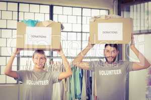 Volunteers carrying donation boxes on head