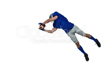 American football player catching ball in mid-air