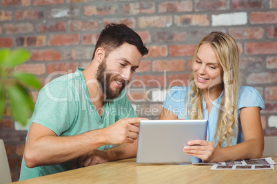 Happy colleagues discussing in officee