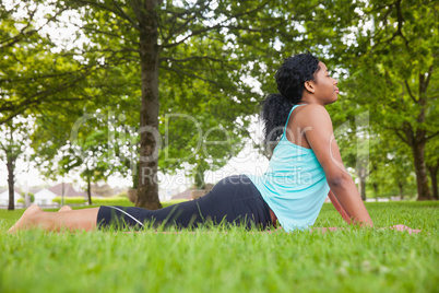 Young woman doing yoga on mat