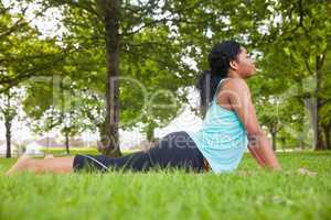 Young woman doing yoga on mat