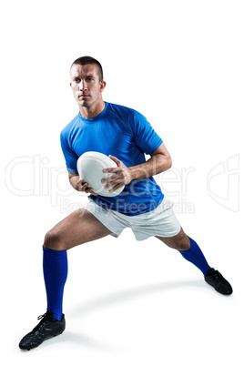 Full length of rugby player exercising with ball