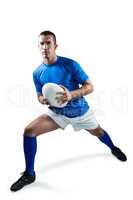 Full length of rugby player exercising with ball