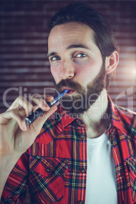 Portrait of man smoking electronic cigarette