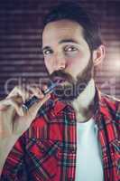 Portrait of man smoking electronic cigarette
