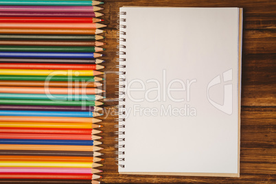 Colour pencils on desk with notepad