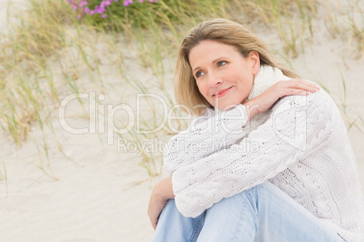 Woman sitting near the sandy hill