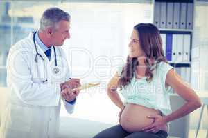 Doctor in conversation with pregnant woman