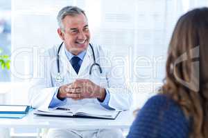 Smiling male doctor with woman in clinic