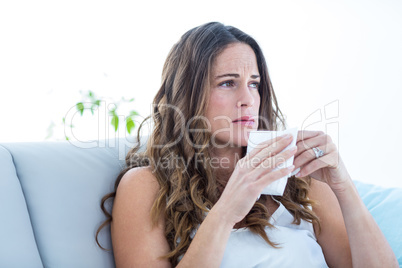 Sad woman sitting on sofa