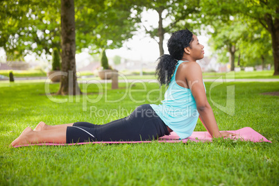 Young woman doing yoga on mat