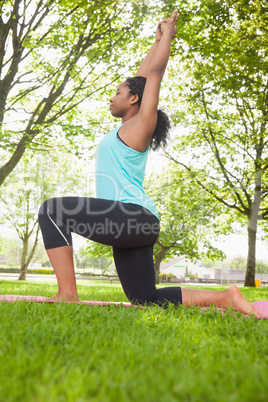 Young woman doing yoga on mat
