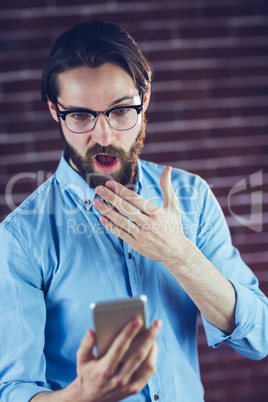 Shocked man using smartphone