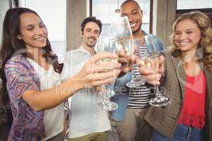 Colleagues toasting with champagne in office