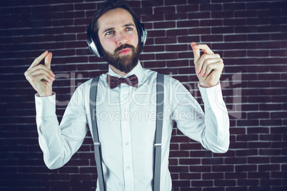 Handsome hipster looking away while listening music