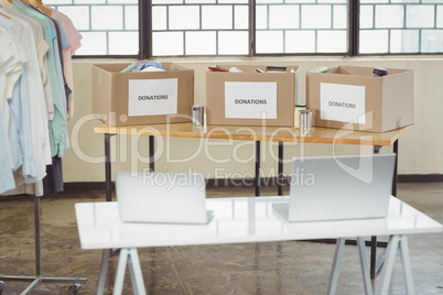 Laptops and donation boxes on table