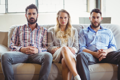 Portrait of serious business people sitting on sofa