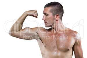 Confident shirtless athlete flexing muscles