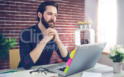 Confident creative editor using laptop