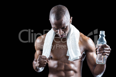 Athlete with towel around neck holding water bottle