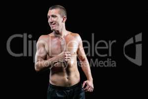 Smiling handsome shirtless athlete running
