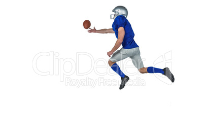 American football player trying to catch the ball