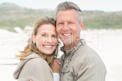 Smiling couple holding one another Smiling couple holding one another