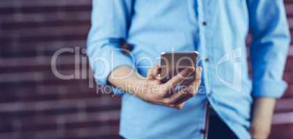 Midsection of man holding cellphone