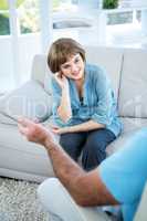 Smiling beautiful woman sitting on sofa