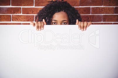 Smiling woman holding white board