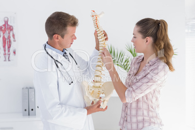 Doctor explaining anatomical spine to his patient