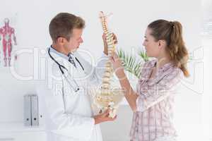 Doctor explaining anatomical spine to his patient