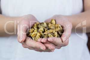 Woman showing handful of walnuts