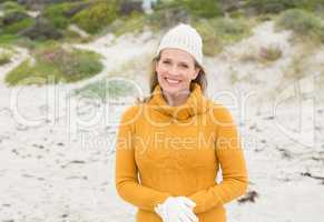 Smiling woman wearing gloves and a hat