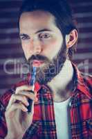 Man with electronic cigarette looking away