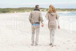 Happy couple holding hands while walking