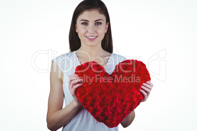 Woman holding heart shape cushion
