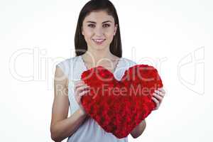 Woman holding heart shape cushion