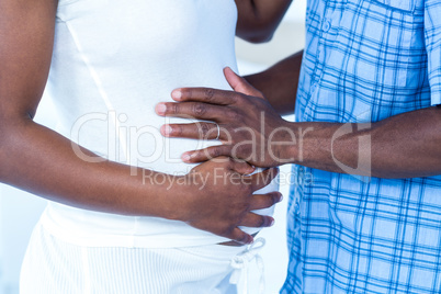 Husband touching belly of wife