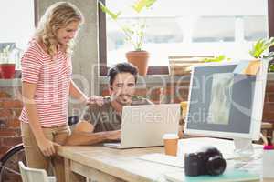 Business people working on laptop in office