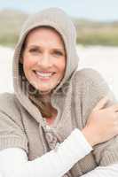 Smiling woman standing on the sand