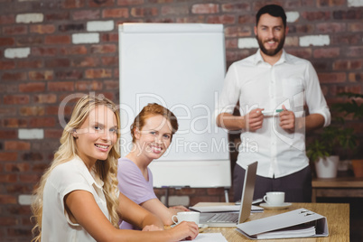 Portrait of happy man and women during presentation