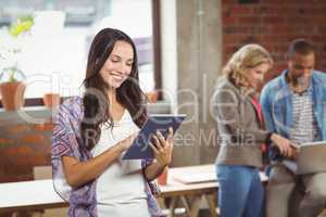 Young businesswoman using digital tablet in office