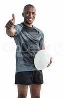 Portrait of confident rugby player smiling and showing thumbs up