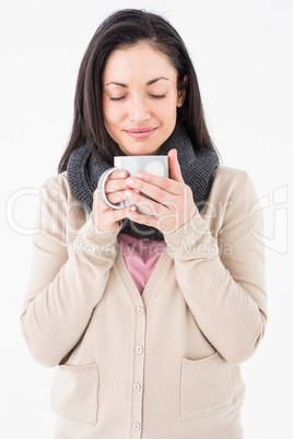 Smiling woman smelling hot beverage